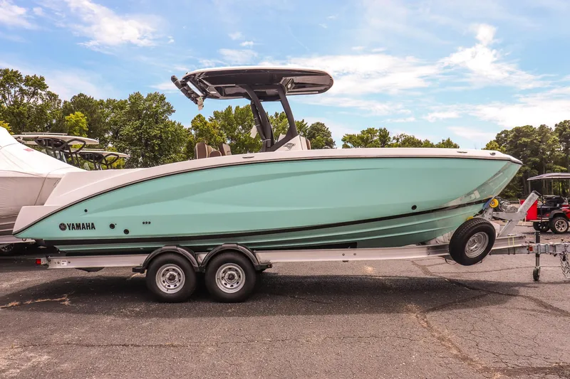 Slide: The Image of 2025 Yamaha Boats 255 FSH Sport E on trailer, side view, outdoors. - 3