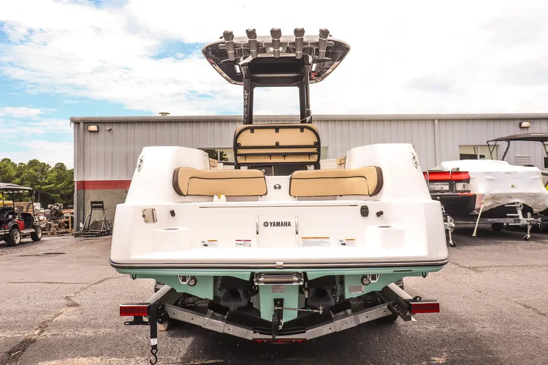 Slide: The Image of 2025 Yamaha Boats 255 FSH Sport E, rear view, parked outdoors. - 5
