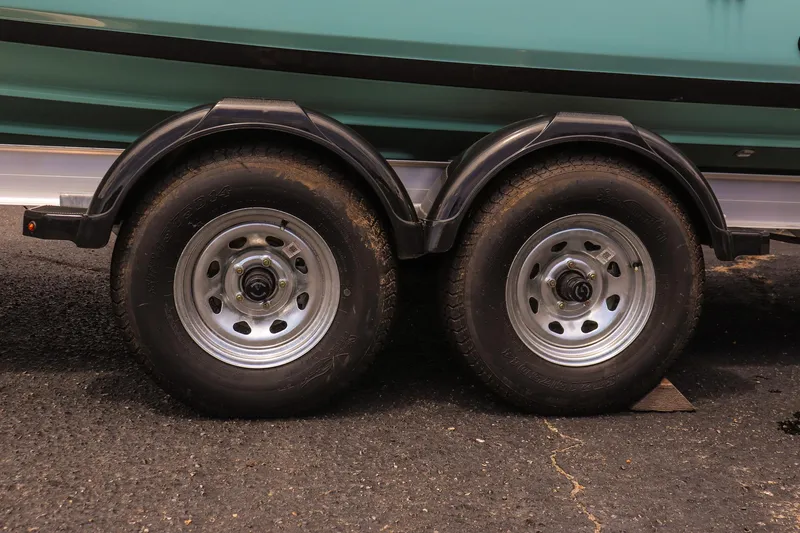 Slide: The Image of Trailer wheels of 2025 Yamaha Boats 255 FSH Sport E on asphalt surface. - 8