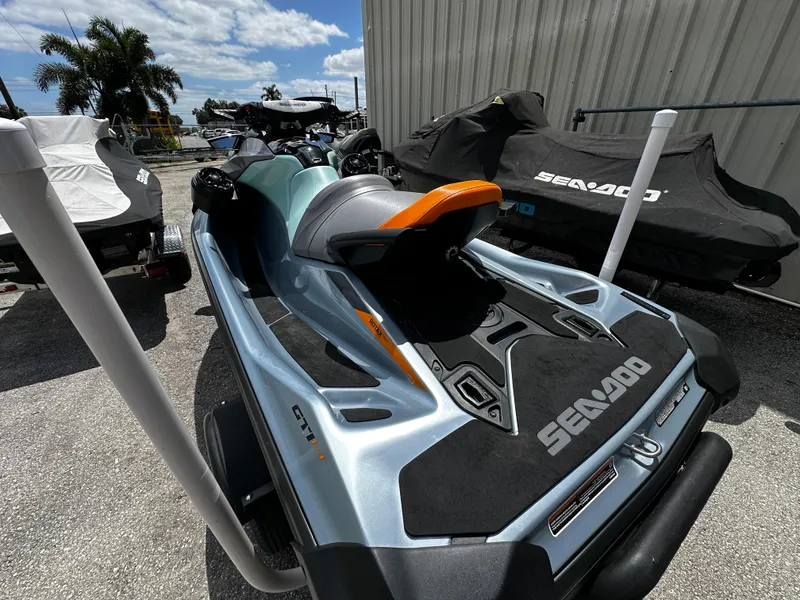 Slide: The Image of 2023 Sea-Doo GTI SE 170 jet ski parked outdoors, under a sunny sky. - 11