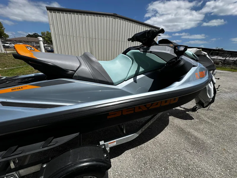 Slide: The Image of 2023 Sea-Doo GTI SE 170 jet ski parked outdoors on a sunny day. - 14