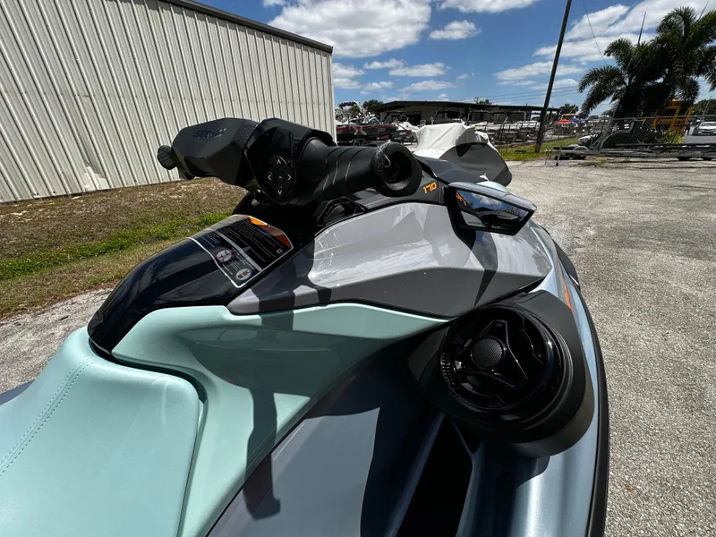 Slide: The Image of 2023 Sea-Doo GTI SE 170 jet ski, close-up view, outdoors under blue sky. - 17