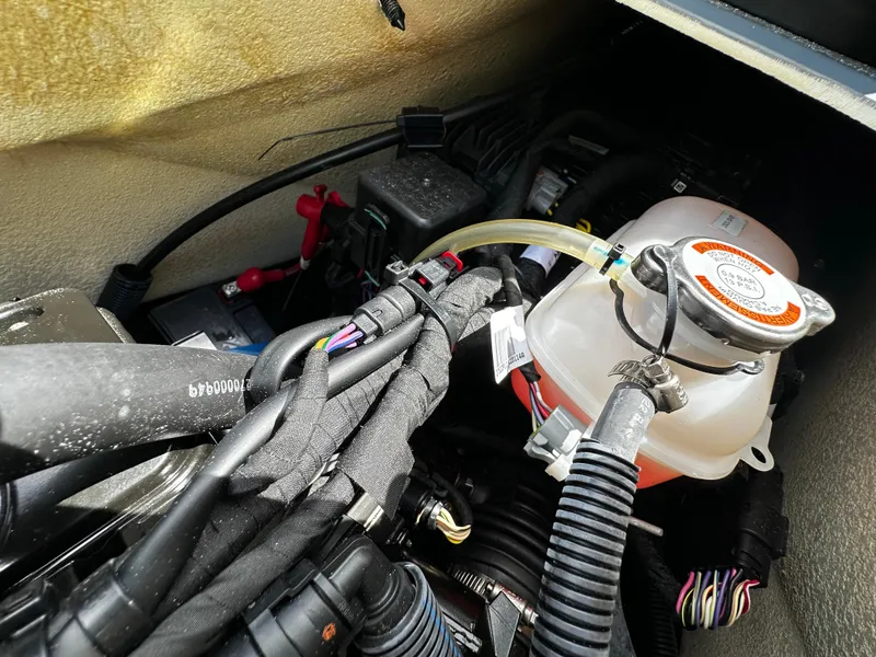 Slide: The Image of Engine compartment of a 2023 Sea-Doo GTI SE 170, showing wiring and coolant reservoir. - 22