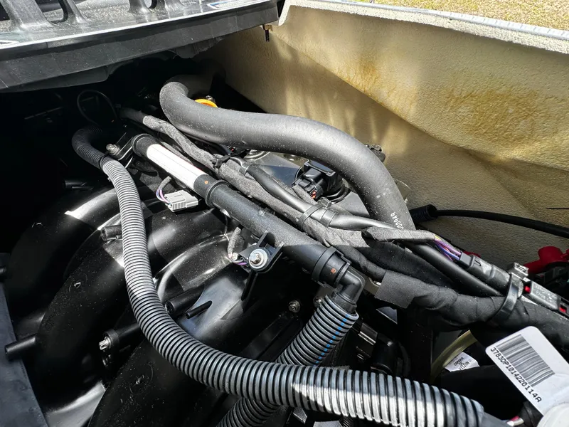 Slide: The Image of Engine compartment of 2023 Sea-Doo GTI SE 170 with visible hoses and wiring. - 23