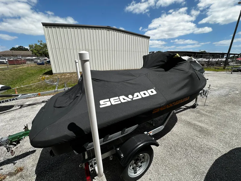 Slide: The Image of 2023 Sea-Doo GTI SE 170 covered on trailer, parked outdoors. - 3