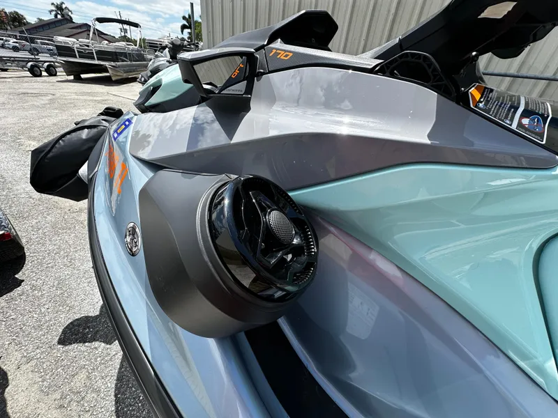 Slide: The Image of 2023 Sea-Doo GTI SE 170 jet ski with speaker, parked outdoors. - 6