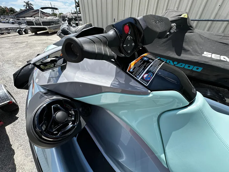 Slide: The Image of 2023 Sea-Doo GTI SE 170 jet ski handlebar and controls, parked outdoors. - 8