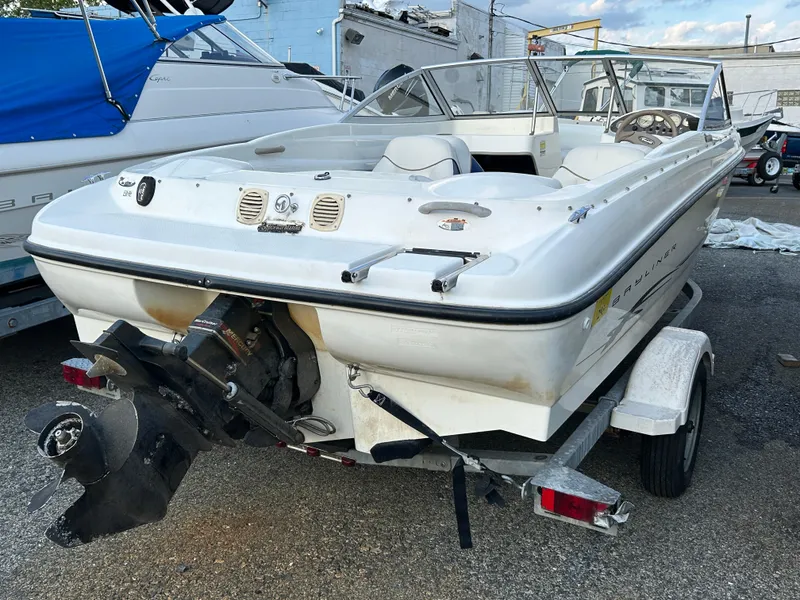 Slide: The Image of 2003 Bayliner 175 Bowrider on trailer, rear view showing outboard motor and seating. - 2