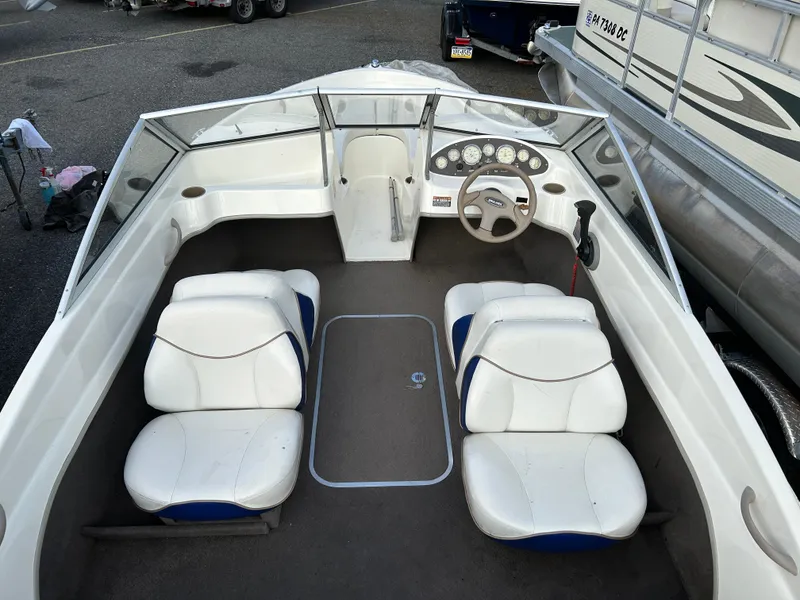 Slide: The Image of 2003 Bayliner 175 Bowrider interior with white seats and steering wheel. - 3