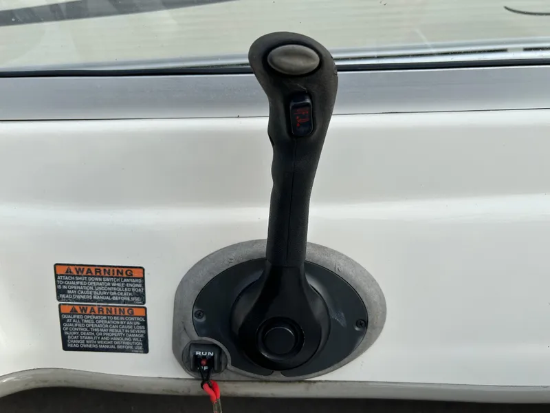 Slide: The Image of Throttle control lever on a 2003 Bayliner 175 Bowrider boat dashboard. - 5