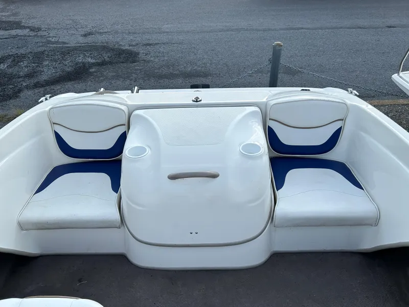 Slide: The Image of 2003 Bayliner 175 Bowrider boat interior with white and blue seating. - 8