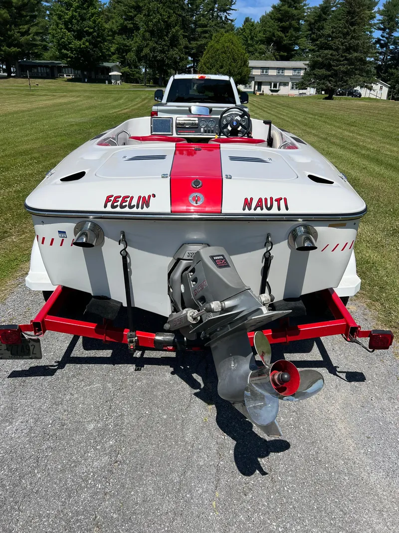 Slide: The Image of 1997 Four Winns U17 boat with "Feelin' Nauti" text, parked on a trailer. - 3