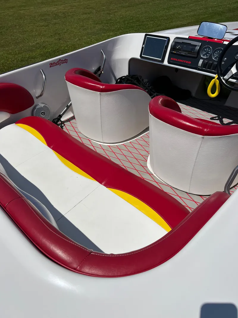 Slide: The Image of Interior of a 1997 Four Winns U17 boat with red and white seating. - 5
