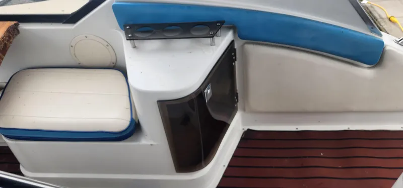 Slide: The Image of Interior seating area of a 1990 Carver 38 Santego boat with blue and white upholstery. - 12