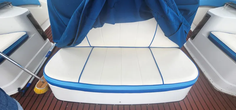 Slide: The Image of White and blue seating on 1990 Carver 38 Santego boat with wooden deck. - 13