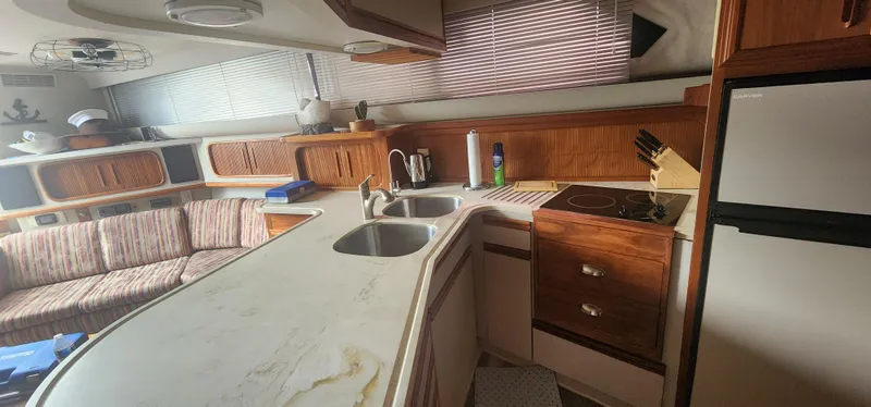Slide: The Image of Interior of 1990 Carver 38 Santego yacht with kitchen and seating area. - 20