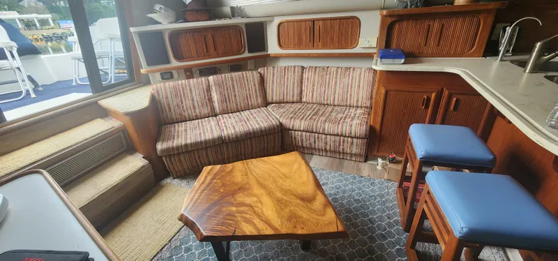 Slide: The Image of Interior of 1990 Carver 38 Santego yacht with striped sofa and wooden table. - 27