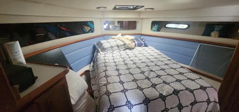 Slide: The Image of Cozy cabin interior of 1990 Carver 38 Santego yacht with bed and porthole windows. - 33