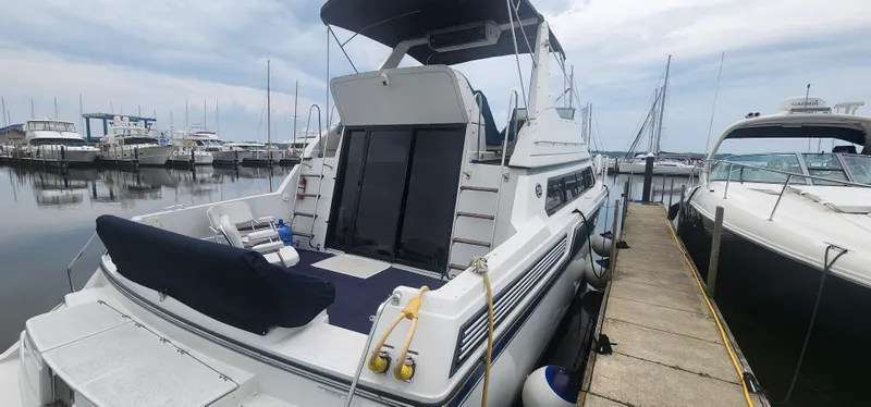 The Image of 1990 Carver 38 Santego yacht docked at marina, featuring spacious deck and sleek design. - 0