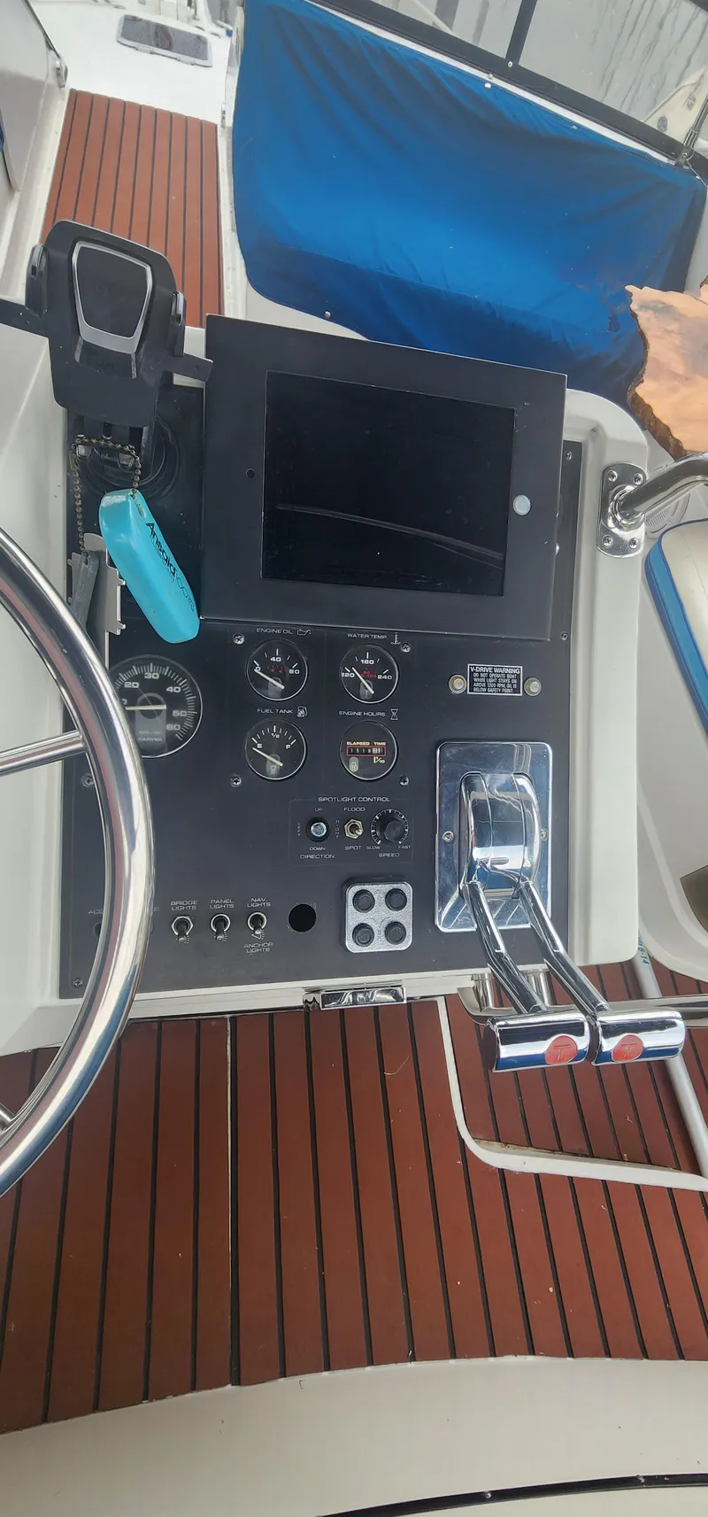 Slide: The Image of 1990 Carver 38 Santego helm with steering wheel, control panel, and throttle levers. - 10