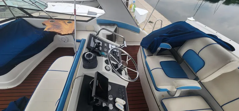 Slide: The Image of Interior view of a 1990 Carver 38 Santego yacht with blue and white seating. - 19