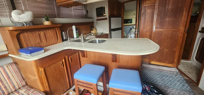Slide: The Image of Interior of 1990 Carver 38 Santego yacht with kitchen and seating area. - 21