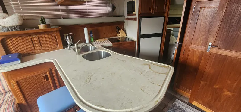 Slide: The Image of Interior of 1990 Carver 38 Santego yacht with kitchen and wooden cabinetry. - 22
