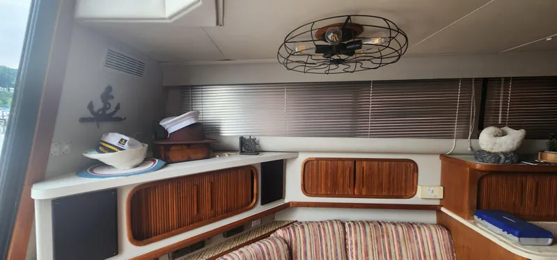 Slide: The Image of Interior of 1990 Carver 38 Santego yacht with nautical decor and striped seating. - 26