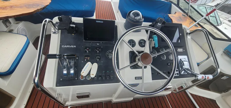 Slide: The Image of Helm of 1990 Carver 38 Santego yacht with steering wheel and navigation controls. - 9