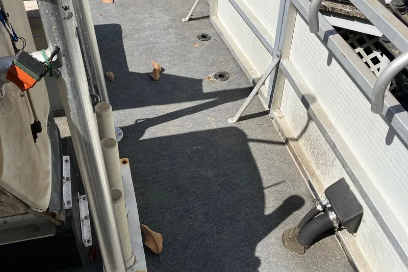 Slide: The Image of 1996 Smoker Craft 820 boat interior with carpeted floor and railing. - 10