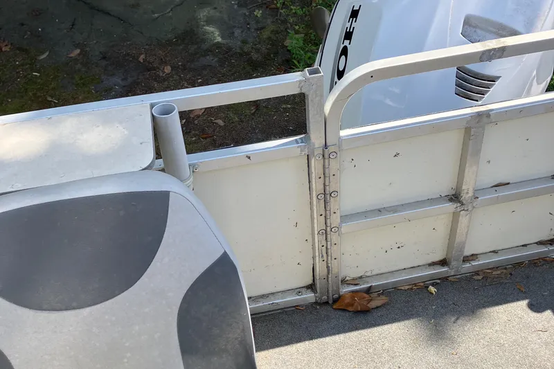 Slide: The Image of 1996 Smoker Craft 820 boat interior with seat and railing detail. - 12