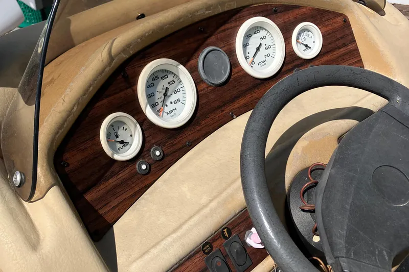 Slide: The Image of 1996 Smoker Craft 820 dashboard with gauges and steering wheel. - 17