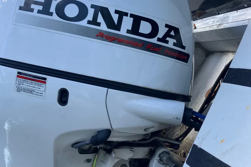 Slide: The Image of Honda outboard motor with programmed fuel injection on a 1996 Smoker Craft 820 boat. - 19