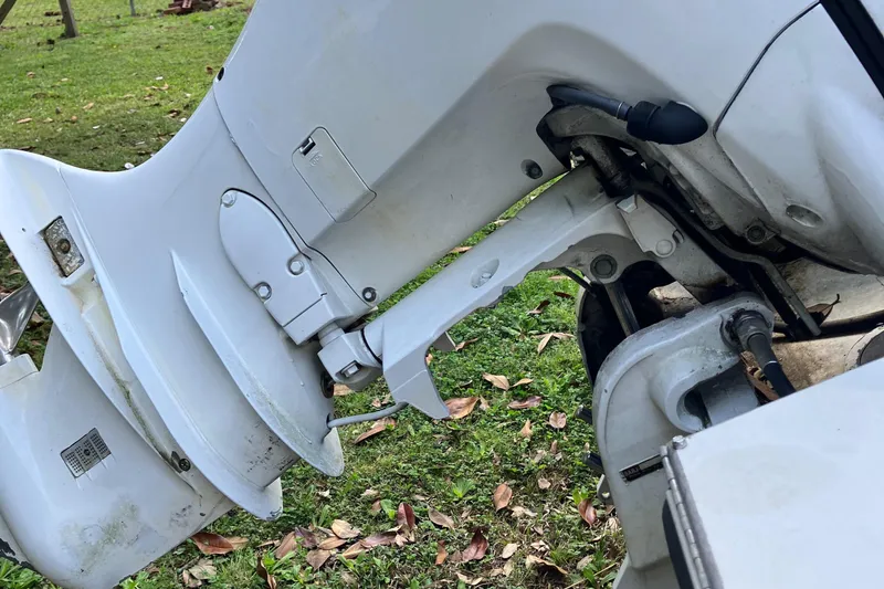 Slide: The Image of Close-up of a 1996 Smoker Craft 820 boat motor on grassy ground. - 20