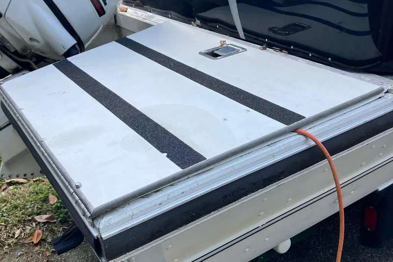 Slide: The Image of 1996 Smoker Craft 820 boat deck with non-slip surface and visible outboard motor. - 21