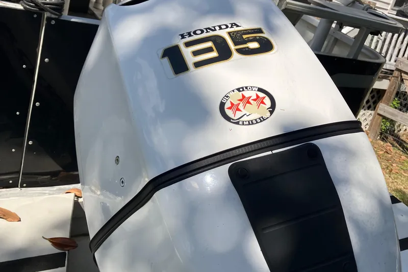 Slide: The Image of Honda 135 outboard motor on 1996 Smoker Craft 820 boat, ultra-low emission sticker visible. - 23