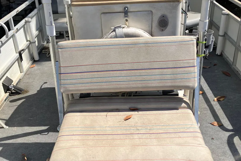 Slide: The Image of 1996 Smoker Craft 820 boat interior with striped seating and visible deck. - 4