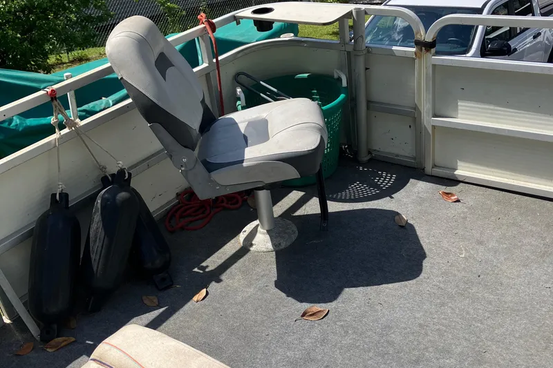 Slide: The Image of 1996 Smoker Craft 820 boat interior with seat, fenders, and basket. - 7