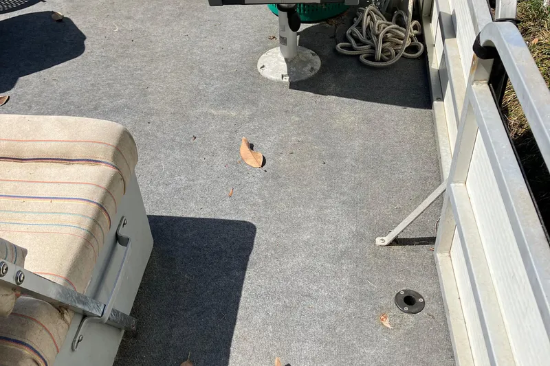 Slide: The Image of Interior of a 1996 Smoker Craft 820 boat with carpeted floor and seating. - 9