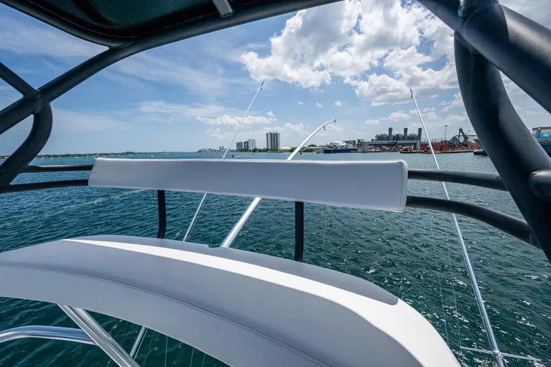 Slide: The Image of 2005 Viking 61 yacht with ocean view and city skyline in the background. - 12