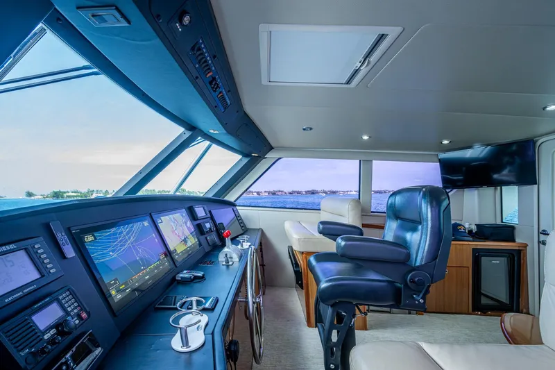 Slide: The Image of Luxurious 2005 Viking 61 yacht helm with advanced navigation systems and plush seating. - 14
