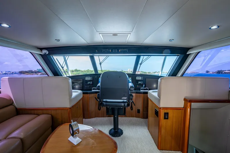 Slide: The Image of Interior view of 2005 Viking 61 yacht helm with luxurious seating and panoramic windows. - 15
