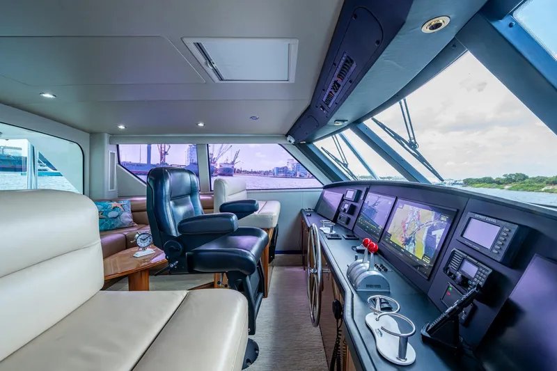 Slide: The Image of Luxurious interior of 2005 Viking 61 yacht with modern navigation equipment and plush seating. - 16
