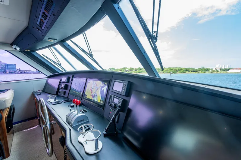 Slide: The Image of Helm of 2005 Viking 61 yacht with navigation screens and controls, overlooking water. - 17