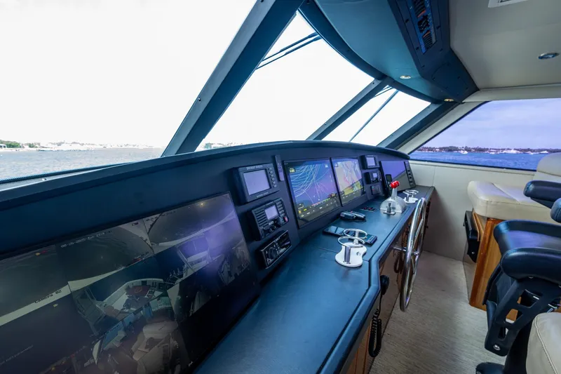 Slide: The Image of Cockpit of 2005 Viking 61 yacht with advanced navigation systems and ocean view. - 18