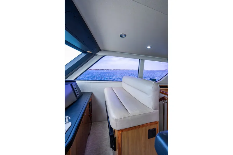 Slide: The Image of Interior view of a 2005 Viking 61 yacht with ocean backdrop through windows. - 19