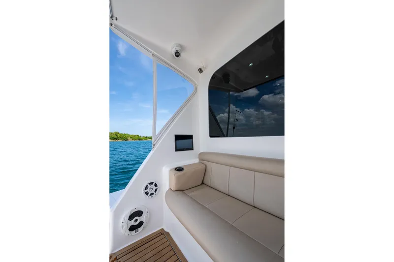 Slide: The Image of Interior view of 2005 Viking 61 yacht with beige seating and ocean backdrop. - 22
