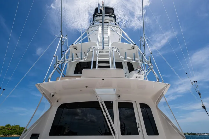 Slide: The Image of 2005 Viking 61 yacht, viewed from below, against a clear blue sky. - 25