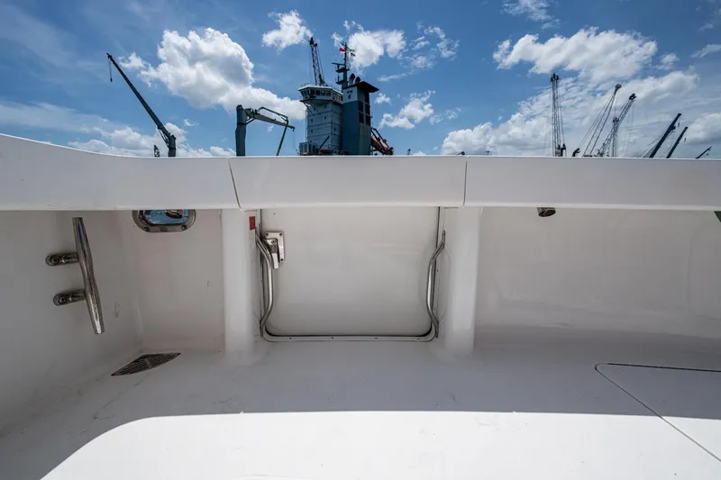 Slide: The Image of 2005 Viking 61 yacht deck with clear sky and cranes in background. - 26