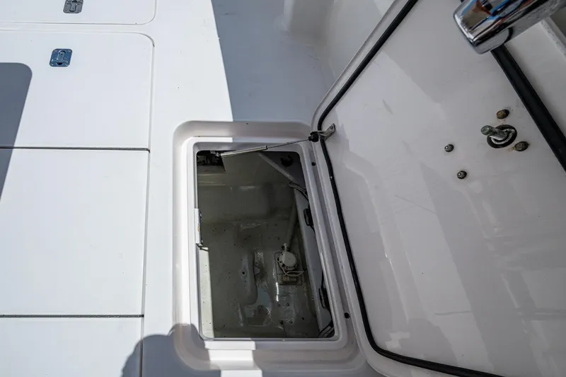 Slide: The Image of Open hatch on 2005 Viking 61 yacht deck, showing storage compartment. - 28
